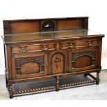 A Victorian oak sideboard, the raised back centred with a carved arch around a lozenge-shaped motif,