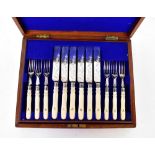 A cased set of twelve silver plated cake knives and forks with bone handles, initialled 'A',