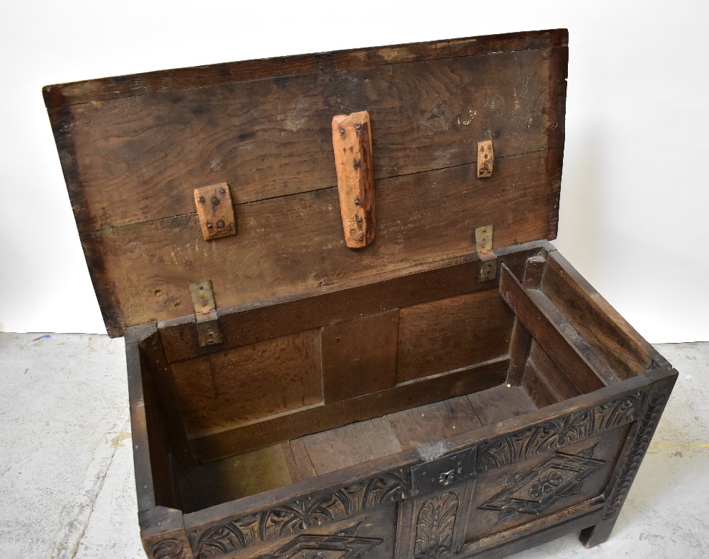 A Georgian oak panelled coffer with plank top and carved geometric and floral panels to the front, - Image 4 of 5