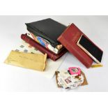 Four stamp albums containing world stamps dating from the mid-20th century, partially complete,