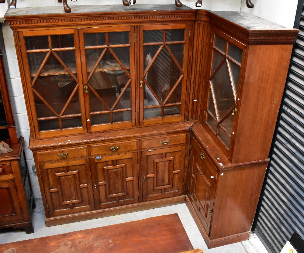 An early 20th century walnut break-front corner bookcase,