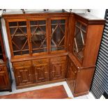 An early 20th century walnut break-front corner bookcase,