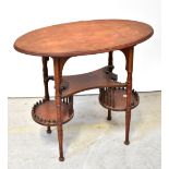 An Edwardian mahogany oval top writing table, possibly American, with carved and shaped undershelf,