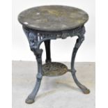 A grey painted cast iron circular garden table with caryatid figures to the upper frieze,