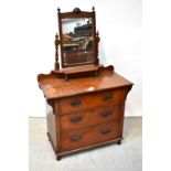 An Edwardian mahogany dressing chest, the top with swing toilet mirror above a shaped single shelf,