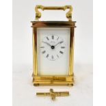 A brass cased English carriage clock by Henley, the painted dial set with Roman numerals,