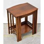 WARING & GILLOW; a nest of three occasional tables with shaped tops and reeded stretchered uprights,