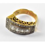 A 14ct gold Art Deco style ring set with four graduated brilliant cut diamonds geometrically
