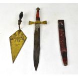 A Masonic dagger with sheath and leather grip, with Masonic engraving to the blade and,