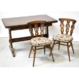 ERCOL; a dark stained extending dining table with two integral leaves beneath the rectangular top,