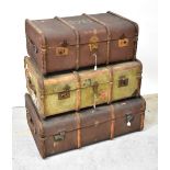 Three wooden bound canvas travelling trunks,