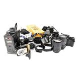 A collection of various modern SLR cameras, lenses and accessories,