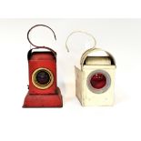 Four early 20th century railway lanterns to include a red Akenco lamp,