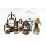 A group of various vintage oil lamps to include miners' lamps, tilly lamps,