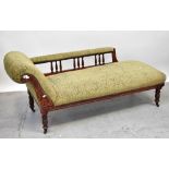 A Victorian mahogany framed chaise longue, scrolling back with curved side rail to carved frieze,