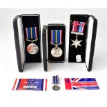 Three boxed medals comprising The Veterans Star and The National Service Medal,