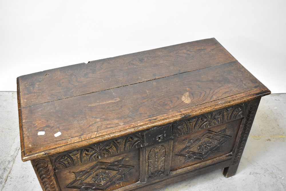 A Georgian oak panelled coffer with plank top and carved geometric and floral panels to the front, - Image 3 of 5