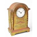 An early 20th century brass cased mantel clock, the enamelled dial set with Arabic numerals,
