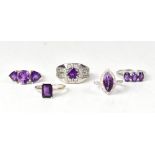Five silver and amethyst rings, to include a three-stone claw set oval amethyst ring, size S,