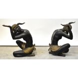 A pair of kneeling figural table supports,