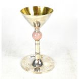 A George V hallmarked silver Arts and Crafts hand planished chalice,