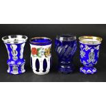 Three 19th century Bohemian Bristol blue overlay glasses comprising a trumpet-shaped example with