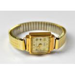 SUTIL; a ladies' c1930s 9ct gold watch head, the square silvered dial set with numbers at 12, 2, 4,