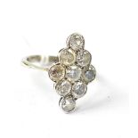 A 9ct white gold ladies' dress ring, the large marquise-shaped top facet set with nine white stones,