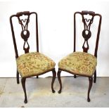 A set of four late 19th century mahogany dining chairs, with Art Nouveau inspired back splat,