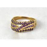 A 9ct yellow gold fancy ring set with two horizontal and one diagonal line of amethyst claw set
