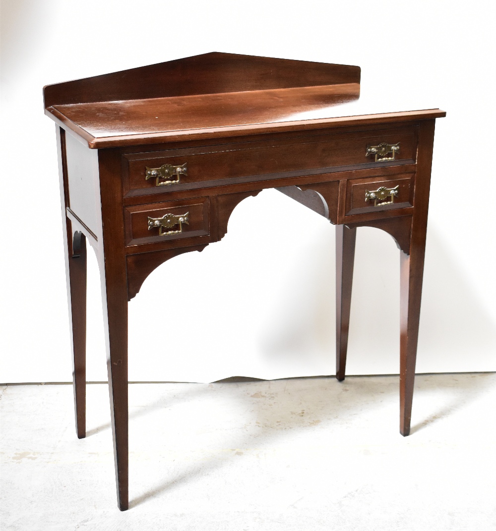 An early 20th century small mahogany desk with long drawer over two smaller drawers,