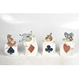 NAO; four figures of children, each wearing a square dress with a playing card suit to the front,