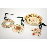 ROYAL CROWN DERBY; three Imari decorated porcelain Christmas ornaments in various colours,