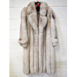 A vintage full-length Arctic silver fox fur coat with silver monogrammed lining and label, 'M.