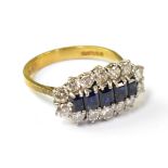 An 18ct gold ring set with central row of emerald cut graduated sapphires,