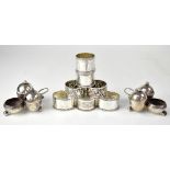 A pair of George V hallmarked silver cruet stands, each set with detachable pepper,