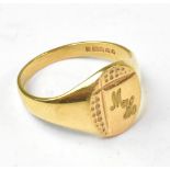 A 9ct gold vintage gentlemen's signet ring with oval head with partial textured design and initials