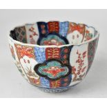 An early 20th century Japanese bowl with fluted sides, decorated in the Imari palette,