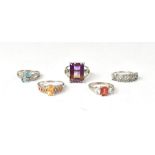 Five sterling silver rings, each set with different gemstones,