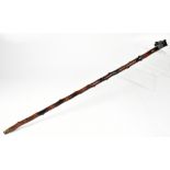 A late 19th early 20th century blackthorn walking stick with carved wooden handle in the form of a