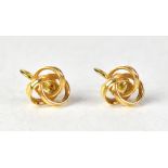 A pair of 14ct yellow gold knot earrings with screw backs, stamped 14K and 585 to the screw backs,