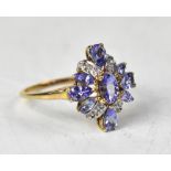 A 9ct gold tanzanite and diamond ring, the flowerhead design comprising oval,