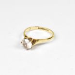 A 9ct gold solitaire ring with claw set white stone, on a 9ct yellow gold shank, size M, approx 2g.