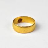 A 22ct gold wide band ring, size N, approx 3.7g.
