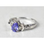 A modern 9ct white gold ring with three claw set pear-shaped tanzanites,