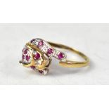 A 9ct gold panther ring encrusted with tiny rubies to the body, on a 9ct gold shank, size P,