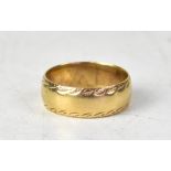 A 9ct gold wide band ring with textured patterned edge, size W, approx 6.5g.