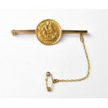 An Edward VII 1906 half sovereign mounted on a 9ct gold hallmarked bar brooch,
