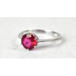 A 9ct white gold ring, with a claw set round red topaz, size O, approx 2.3g.