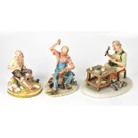 Three Capodimonte figures comprising a shoemaker holding last with boot in one hand and hammer in